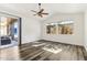 Bedroom with neutral paint, fan, wood flooring, and slider door leading to covered patio at 9429 E Nacoma Dr, Sun Lakes, AZ 85248