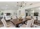 Open dining room with hardwood floors, chandelier, and views into the kitchen and living areas at 9429 E Nacoma Dr, Sun Lakes, AZ 85248