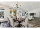 Elegant dining room featuring a chandelier, hardwood floors, and an adjacent sitting and living area at 9429 E Nacoma Dr, Sun Lakes, AZ 85248