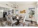 Stylish dining room with hardwood floors, chandelier, and views into the kitchen and backyard at 9429 E Nacoma Dr, Sun Lakes, AZ 85248