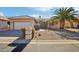 Charming single-story home with desert landscaping, palm tree, and a welcoming front entrance at 9429 E Nacoma Dr, Sun Lakes, AZ 85248