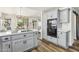 Bright kitchen with an island, modern appliances, gray cabinetry, and wood-look flooring at 9429 E Nacoma Dr, Sun Lakes, AZ 85248