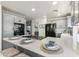Modern kitchen island with cooktop, quartz countertops, stylish barstools, and modern lighting at 9429 E Nacoma Dr, Sun Lakes, AZ 85248