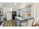 Updated kitchen with gray cabinets, quartz counters, stainless appliances, and wood flooring at 9429 E Nacoma Dr, Sun Lakes, AZ 85248