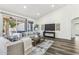 Bright and open living room with hardwood floors, neutral furniture, and access to the backyard at 9429 E Nacoma Dr, Sun Lakes, AZ 85248