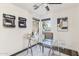 Bright home office featuring a glass top desk, modern art, and views of mature landscaping at 9429 E Nacoma Dr, Sun Lakes, AZ 85248