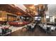 Restaurant with modern lighting, tables, chairs, a bar, and TV screens at 9429 E Nacoma Dr, Sun Lakes, AZ 85248