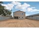 Expansive backyard featuring dirt landscaping, block wall fencing, and a neutral-colored stucco home with bright white trim at 9522 W Luxton Ln, Tolleson, AZ 85353