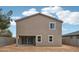 Expansive backyard showcasing neutral colored stucco home with bright white trim and a sliding glass door at 9522 W Luxton Ln, Tolleson, AZ 85353