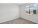 Neutral bedroom featuring plush carpeting, and a window offering natural light at 9522 W Luxton Ln, Tolleson, AZ 85353