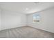 Clean bedroom with neutral decor, plush carpeting, and a window offering outside views at 9522 W Luxton Ln, Tolleson, AZ 85353