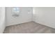 Well-lit bedroom featuring plush carpeting, white walls, and bright windows at 9522 W Luxton Ln, Tolleson, AZ 85353