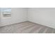 Neutral bedroom featuring plush carpeting, white walls, and bright window at 9522 W Luxton Ln, Tolleson, AZ 85353