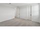 Bright bedroom featuring plush carpeting, white walls, and two doors at 9522 W Luxton Ln, Tolleson, AZ 85353