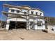 Exterior construction of a two-story home with scaffolding surrounding the building and a blue sky in the background at 9522 W Luxton Ln, Tolleson, AZ 85353