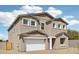 Charming two-story home features a stucco exterior, a two-car garage, and a well-maintained lawn at 9522 W Luxton Ln, Tolleson, AZ 85353