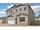 Charming two-story home features a stucco exterior, a two-car garage, and a well-maintained lawn at 9522 W Luxton Ln, Tolleson, AZ 85353