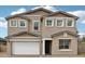Charming two-story home features a stucco exterior, a two-car garage, and a well-maintained lawn at 9522 W Luxton Ln, Tolleson, AZ 85353