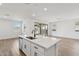Bright kitchen boasts a center island, stainless dishwasher and sliding door access to the backyard at 9522 W Luxton Ln, Tolleson, AZ 85353