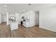 Modern kitchen featuring white cabinets, stainless appliances and a large center island with breakfast bar at 9522 W Luxton Ln, Tolleson, AZ 85353