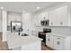 Well-equipped kitchen featuring stainless steel appliances, white cabinetry and sleek countertops at 9522 W Luxton Ln, Tolleson, AZ 85353