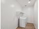 Efficient laundry room with modern appliances, storage shelves, and tile flooring at 9522 W Luxton Ln, Tolleson, AZ 85353