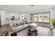 Bright, open-concept living space with island kitchen, dining area and large sliding doors to the backyard at 9522 W Luxton Ln, Tolleson, AZ 85353