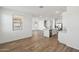 Bright open-concept living area with wood-look floors, a central island and a staircase in view at 9522 W Luxton Ln, Tolleson, AZ 85353