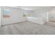 Bright and airy loft space with plush carpeting and natural light from two windows at 9522 W Luxton Ln, Tolleson, AZ 85353