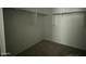 The walk-in closet includes carpeting and ample storage with shelves and racks at 9522 W Luxton Ln, Tolleson, AZ 85353