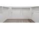 Large walk-in closet with ample shelving and carpeting for organized storage at 9522 W Luxton Ln, Tolleson, AZ 85353