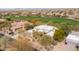 Overhead view of the desert home set on a golf course, showcasing the surrounding greenery at 9626 E Peak View Rd, Scottsdale, AZ 85262