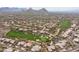Expansive aerial view of a luxury golf community with lush green fairways, pools, and upscale homes at 9626 E Peak View Rd, Scottsdale, AZ 85262