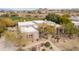 Expansive aerial view of the desert home highlighting mature landscaping and circular driveway at 9626 E Peak View Rd, Scottsdale, AZ 85262