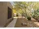 Scenic backyard featuring desert landscaping, mature trees, and a serene outdoor environment at 9626 E Peak View Rd, Scottsdale, AZ 85262