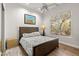 Cozy bedroom with a wooden frame bed, bright natural light, and stylish decor at 9626 E Peak View Rd, Scottsdale, AZ 85262