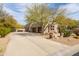 Stunning home with a large driveway, desert landscaping, and a three-car garage at 9626 E Peak View Rd, Scottsdale, AZ 85262