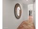 Elegant hallway with a decorative mirror and beautiful terra cotta tile flooring at 9626 E Peak View Rd, Scottsdale, AZ 85262