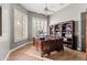 Elegant home office featuring a wooden desk, custom bookcase, and bright natural light at 9626 E Peak View Rd, Scottsdale, AZ 85262