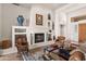 Cozy living room featuring a fireplace, built-in shelving, and comfortable seating at 9626 E Peak View Rd, Scottsdale, AZ 85262