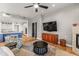 The bright living room has a fireplace, flatscreen TV, and opens to the modern, well-equipped kitchen at 9626 E Peak View Rd, Scottsdale, AZ 85262