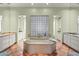 The luxurious main bathroom features a large soaking tub, dual vanities, and lots of natural light at 9626 E Peak View Rd, Scottsdale, AZ 85262