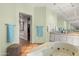 The spa-like bathroom boasts a soaking tub, dual vanities, and lots of mirrored storage at 9626 E Peak View Rd, Scottsdale, AZ 85262