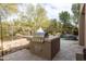 A built-in outdoor kitchen with a stainless steel grill, perfect for al fresco dining at 9626 E Peak View Rd, Scottsdale, AZ 85262