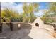 Outdoor kitchen with built-in grill and pizza oven at 9626 E Peak View Rd, Scottsdale, AZ 85262