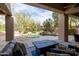 Scenic backyard view showcasing a sparkling pool and a cozy seating area at 9626 E Peak View Rd, Scottsdale, AZ 85262