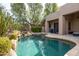 Desert home backyard with a pristine pool, spa, waterfall, and outdoor seating area at 9626 E Peak View Rd, Scottsdale, AZ 85262