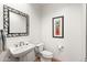 Chic powder room featuring a pedestal sink, decorative mirror, and elegant artwork at 9626 E Peak View Rd, Scottsdale, AZ 85262