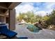 Beautiful backyard featuring a sparkling pool, outdoor kitchen, and lush desert landscaping at 9626 E Peak View Rd, Scottsdale, AZ 85262
