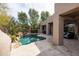 Lush backyard with a sparkling swimming pool, waterfall feature, and desert landscaping at 9626 E Peak View Rd, Scottsdale, AZ 85262